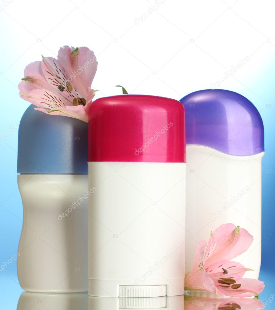 deodorants with flowers on blue background