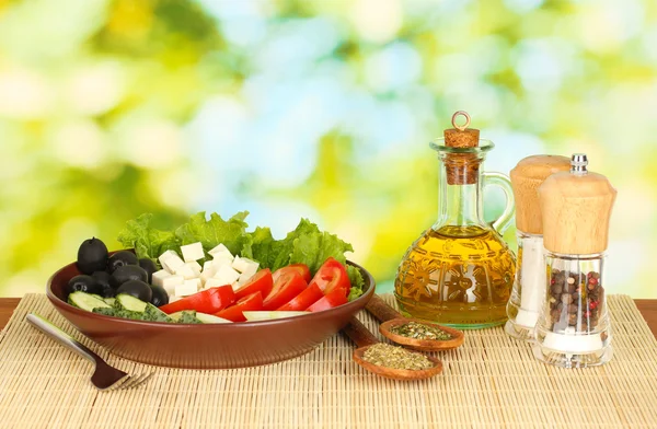 Tasty greek salad on bright green background — Stock Photo, Image