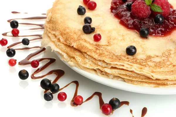Delicious pancakes with berries and jam on plate isolated on white — Stock Photo, Image