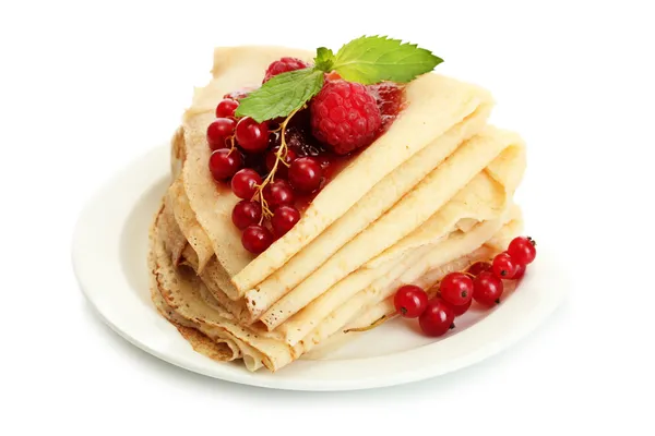 Delicious pancakes with berries and jam on plate on wooden table — Stock Photo, Image