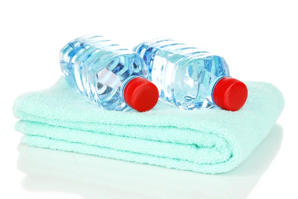 Plastic bottles of water on towel isolated on white — Stock Photo, Image