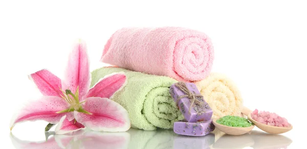 Towels with beautiful pink lily, aroma oil and sea salt isolated on white — Stock Photo, Image