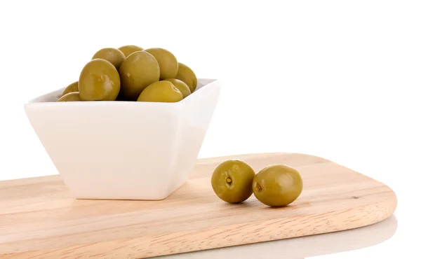 Green olives in white bowl on board isolated on white — Stock Photo, Image