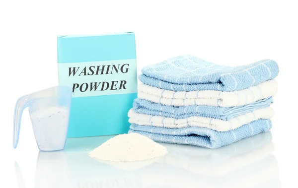 Box of washing powder with blue measuring cup and towels, isolated on white — Stock Photo, Image