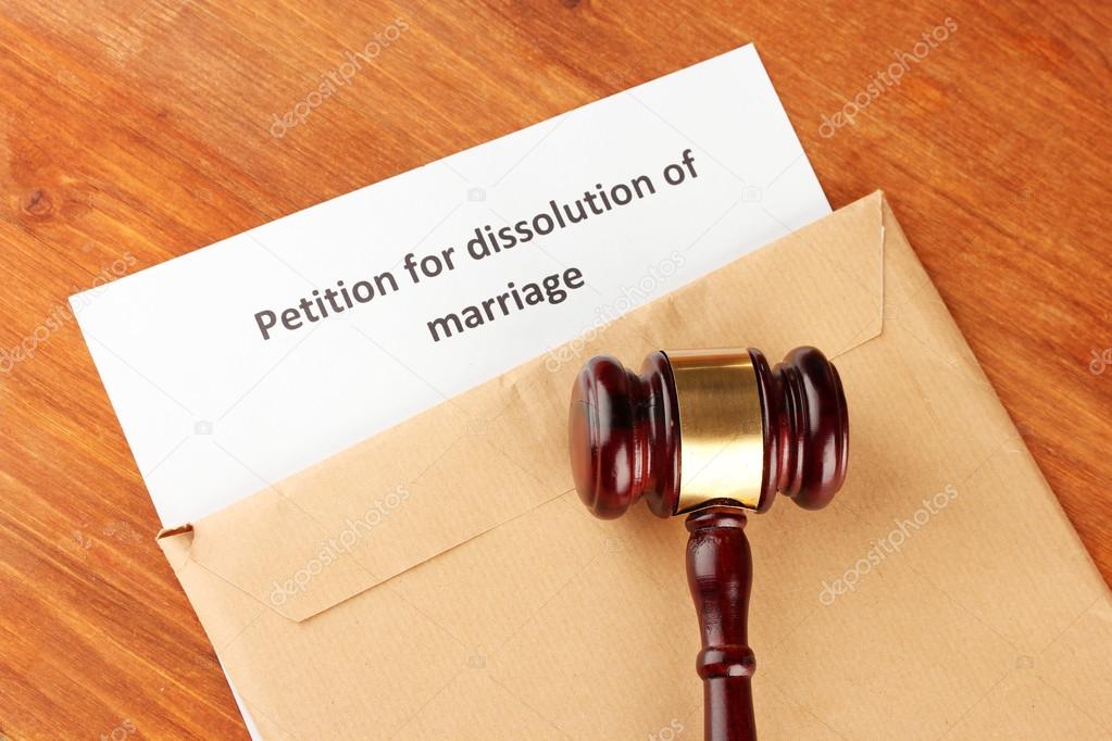 Divorce decree and envelope on wooden background
