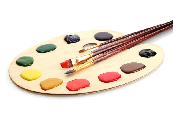 Wooden art palette with paint and brushes isolated on white — Stock Photo, Image