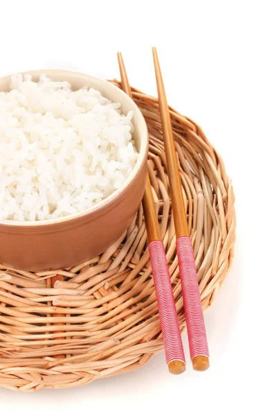 Bowl of rice and chopsticks on wicker mat isoalted on white — Stock Photo, Image