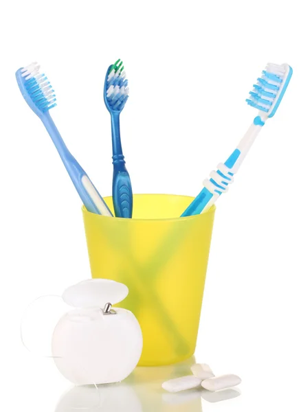 Toothbrushes, chewing gum and dental floss isolated on white — Stock Photo, Image