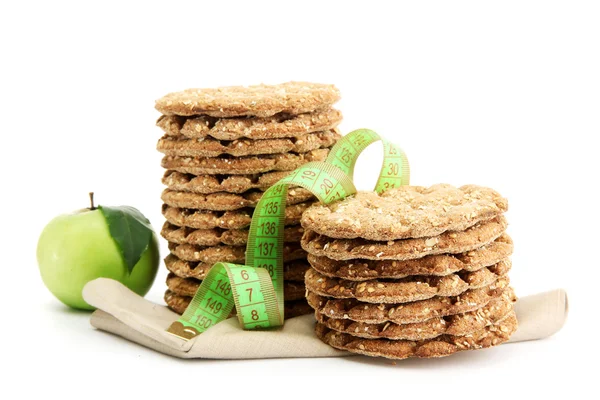 Tasty crispbread, apple and measuring tape, isolated on white — Stock Photo, Image