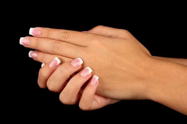 Belle mani di donna con manicure francese su sfondo nero — Foto Stock