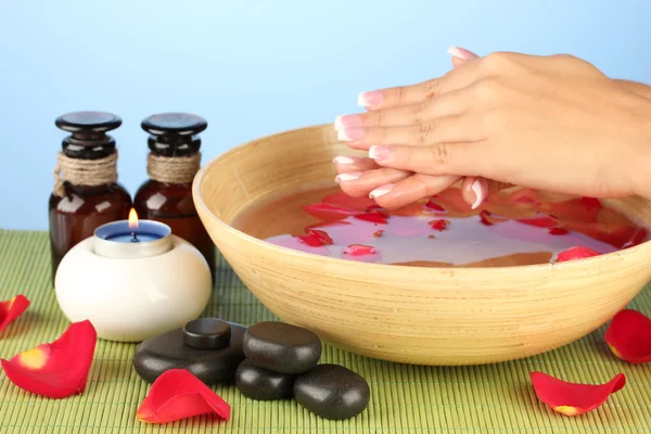 Spa treatments for female hands, on blue background — Stock Photo, Image