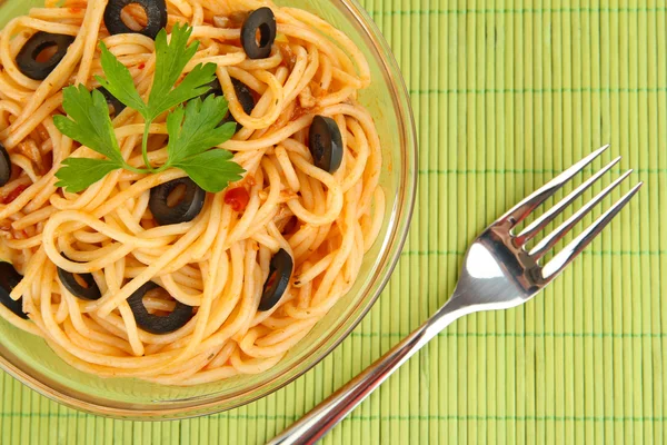 Italiaanse spaghetti in glazen kom op bamboe mat close-up — Stockfoto