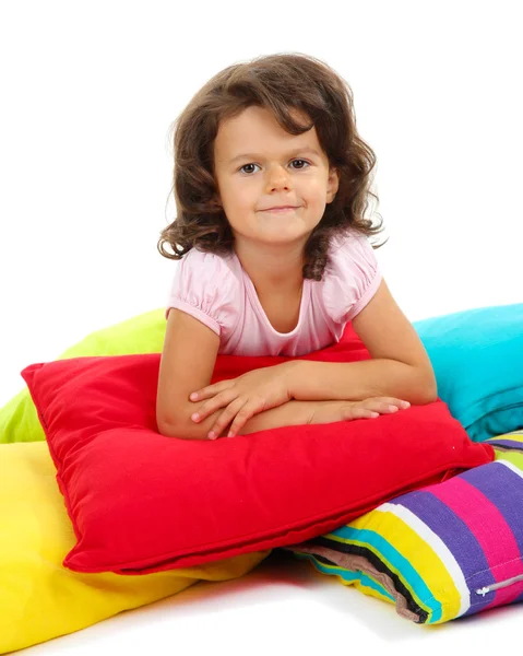 Beautiful little girlwith pillows isolated on white — Stock Photo, Image