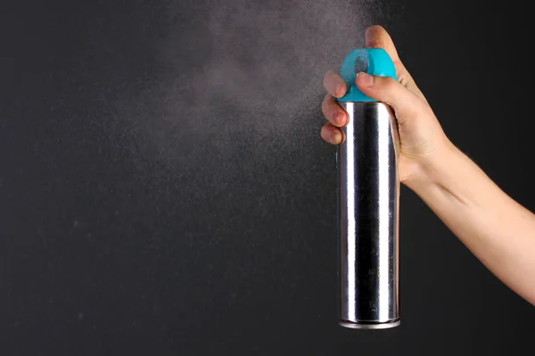 Sprayed air freshener in hand on grey background — Stock Photo, Image