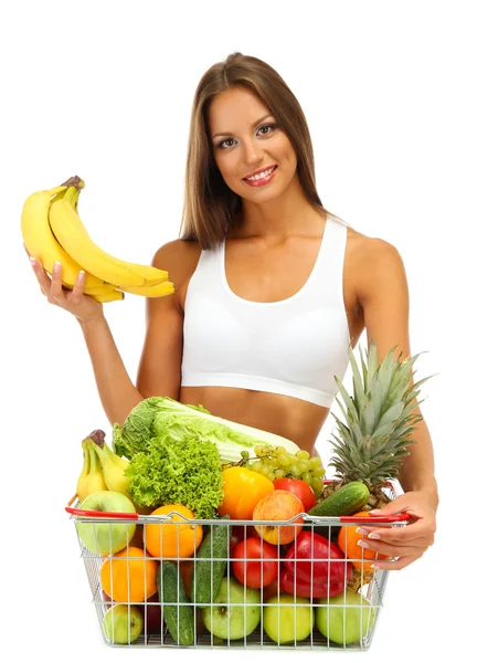 Beautiful young woman with fruits and vegetables in shopping basket, isolat — Stock Photo, Image