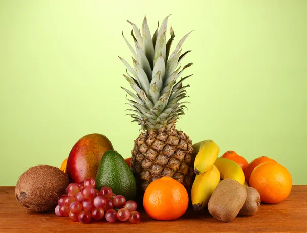 Still life of fruit on a table on a green background — Stock Photo, Image