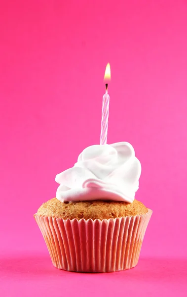 Tasty birthday cupcake with candle, on pink background Royalty Free Stock Photos