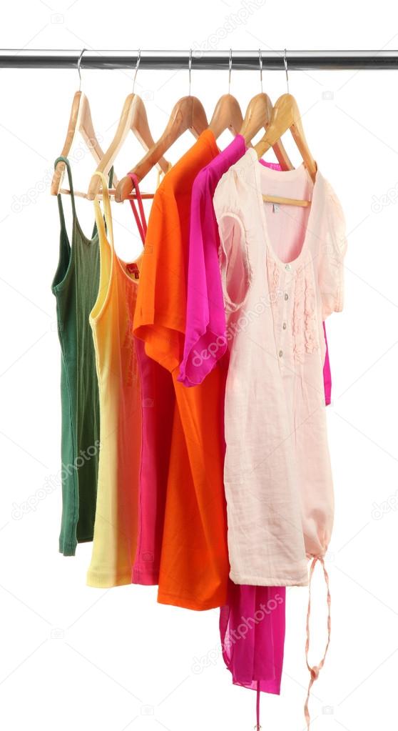 different clothes on wooden hangers isolated on white