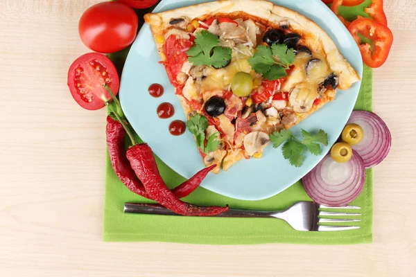 Delicious slice of pizza on color plate with ingredients around close-up on — Stock Photo, Image