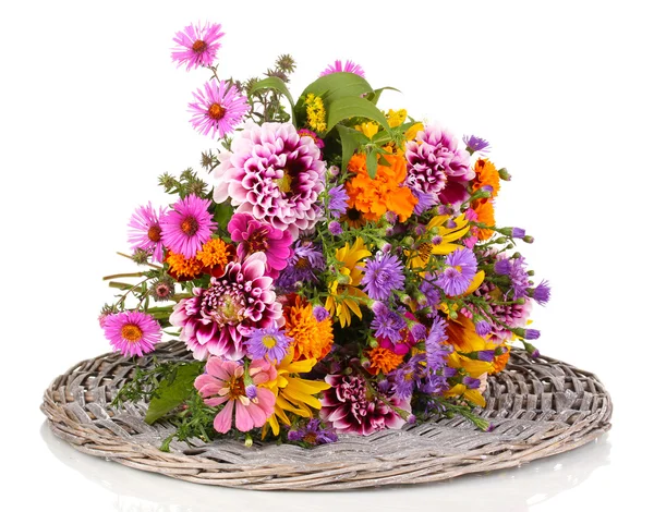 Beautiful bouquet of bright flowers on wicker mat isolated on white — Stock Photo, Image