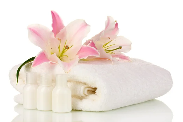 Beautiful lily with towel and bottles isolated on white — Stock Photo, Image