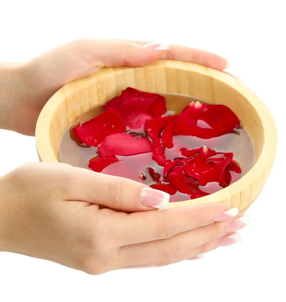 Woman hands with wooden bowl of water with petals, isolated on white — Stock Photo, Image