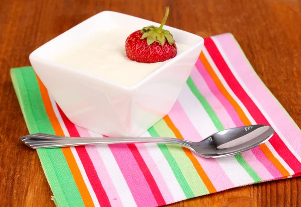 Glass of ripe strawberries with cream on wooden background — Stock Photo, Image