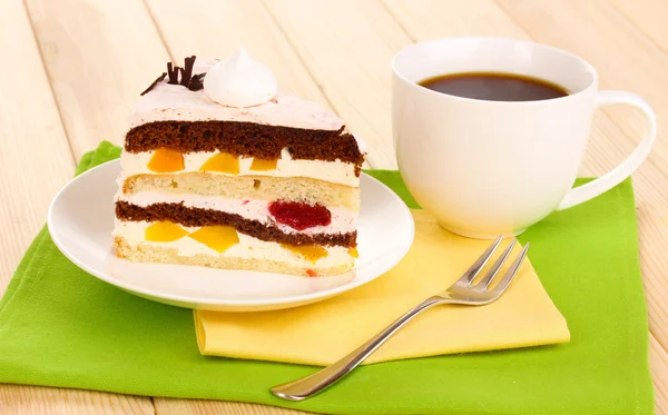 Layered fruit cake on wooden table — Stock Photo, Image