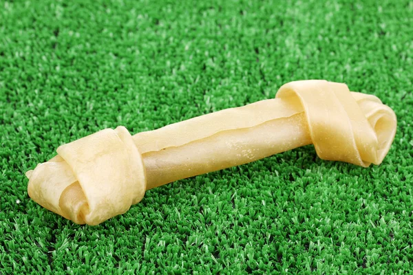 Dog bone on green grass — Stock Photo, Image