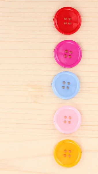 Colorful sewing buttons on wooden background — Stock Photo, Image