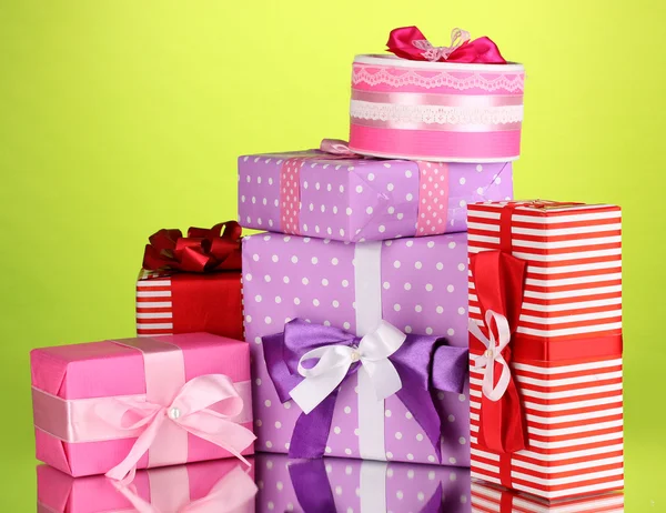 Colorful gifts on green background — Stock Photo, Image