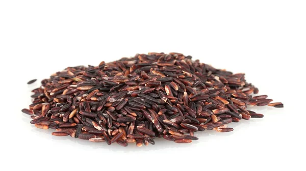 Black rice uncooked in a heap isolated on a white background — Stock Photo, Image
