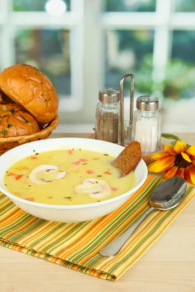 Fragrant soup in white plate on table on window background close-up — Stock Image Fragrant soup in white plate on table on window background close-up Royalty Free Stock Photos