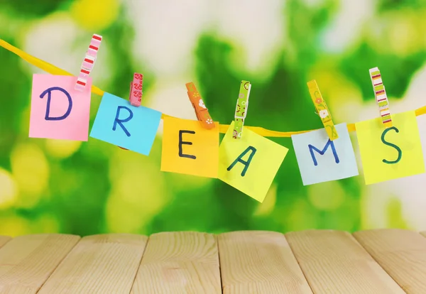 The word Dreams on wooden table on natural background — Stock Photo, Image