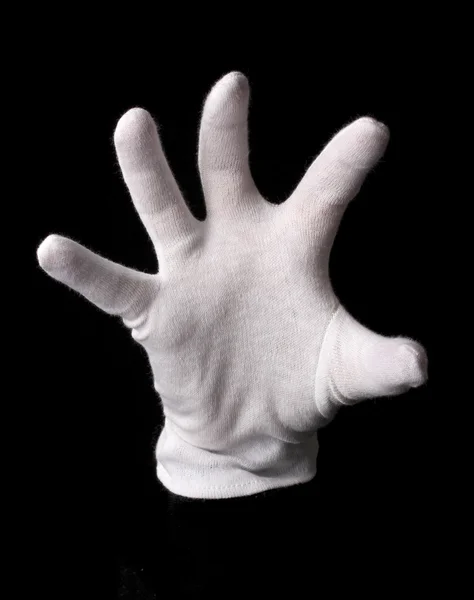 Hand in witte handschoen maken van teken geïsoleerd op zwart — Stockfoto