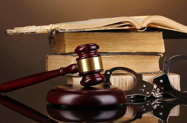 Gavel, handcuffs and book on law on brown background — Stock Photo, Image