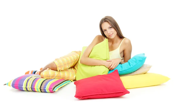 Beautiful young girl with pillows isolated on white — Stock Photo, Image