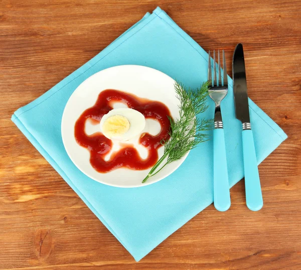 Boiled egg with ketchup on wooden background — Stock Photo, Image