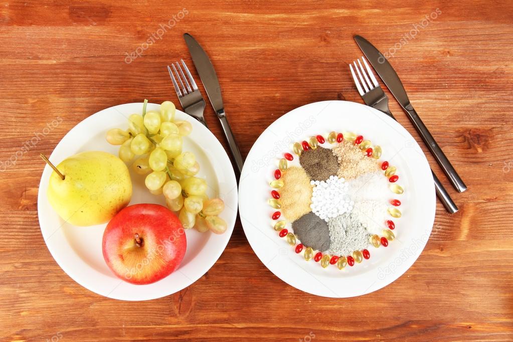 Nutritional supplements on wooden background close-up