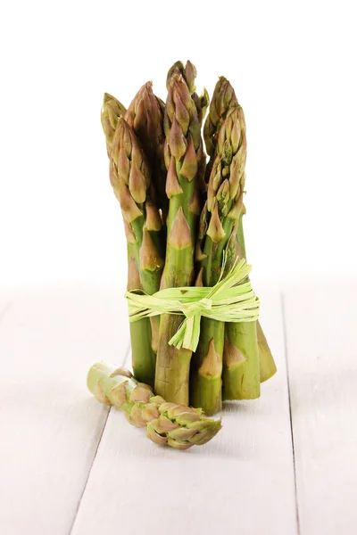 Useful asparagus on wooden table on white background — Stock Photo, Image