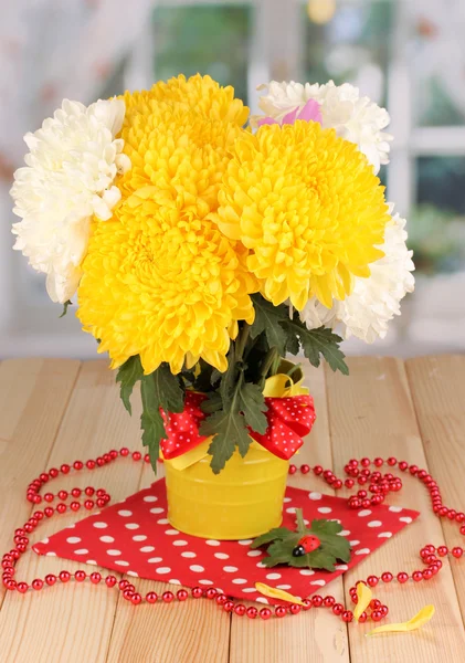 Beautiful chrysanthemum in pail on wooden table on window background — Stock Photo, Image