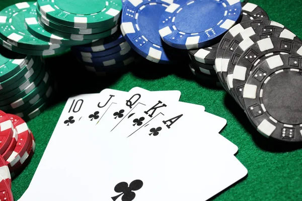 Cards and chips for poker on green table — Stock Photo, Image