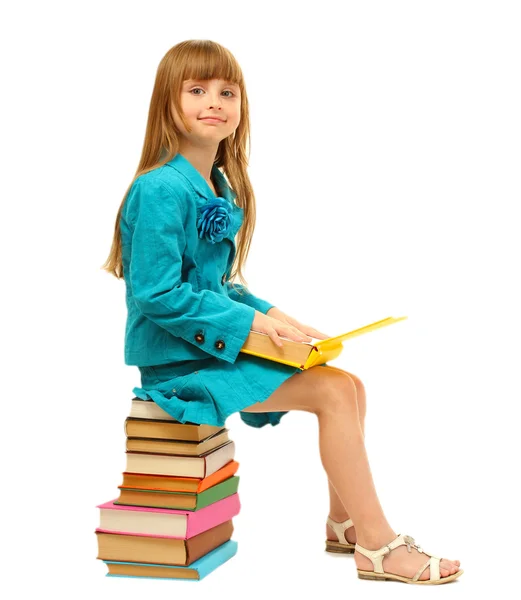 Маленькая девочка с книгами, изолированными на белом — стоковое фото