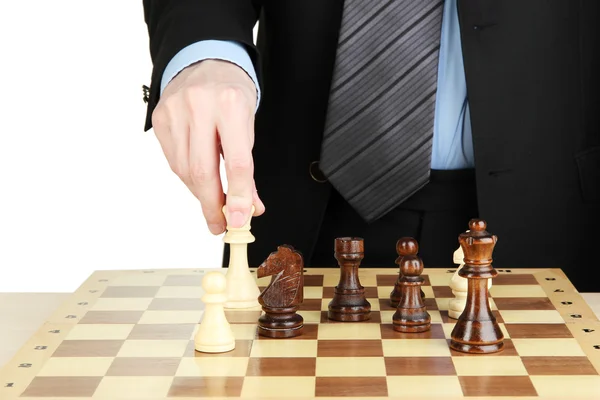 Hombre de negocios jugando ajedrez aislado en blanco — Foto de Stock