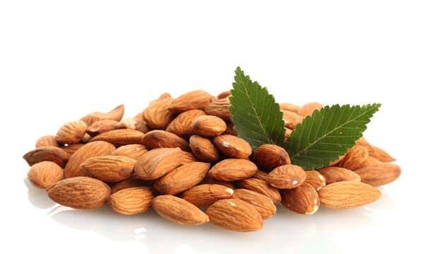 tasty almonds nuts with leaves, isolated on white