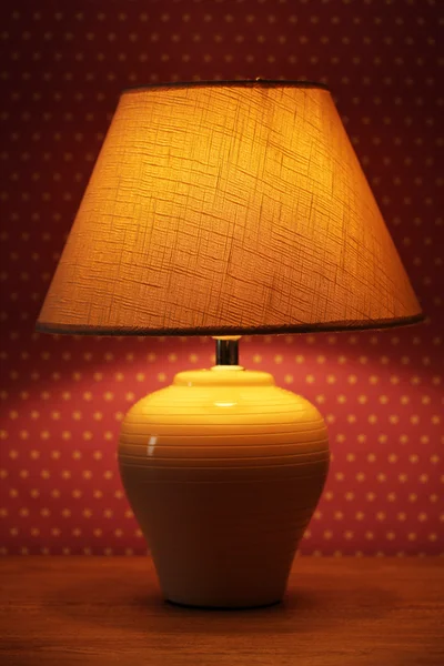 Table lamp on wallpaper background Royalty Free Stock Images