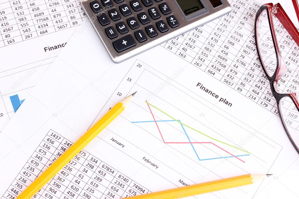 Documents, calculator and glasses close-up