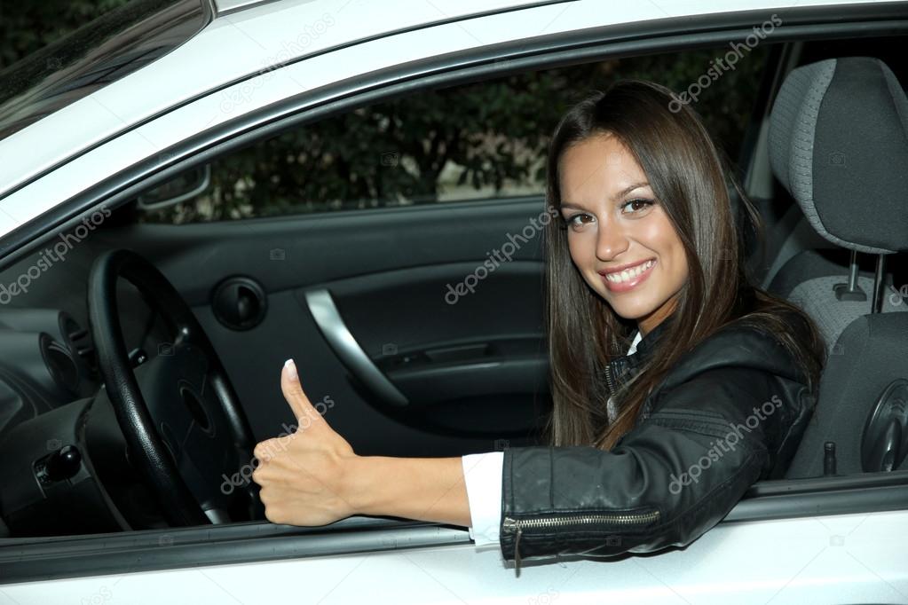 beautiful young woman in car