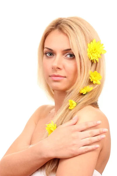 Beautiful young woman with a bright yellow chrysanthemums in her hair on wh — Stock Photo, Image