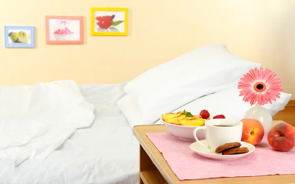 Pequeno-almoço leve na mesa de cabeceira ao lado da cama — Fotografia de Stock